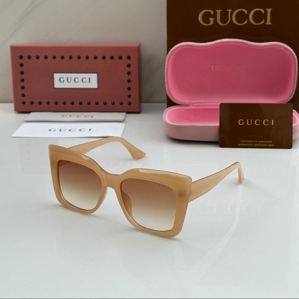 Gucci sunglasses with pink case and packaging on a white background