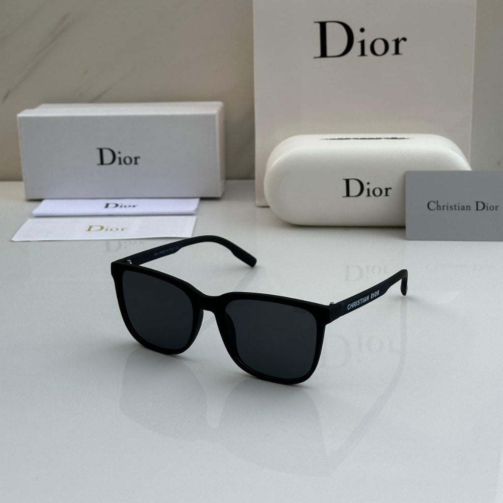 Black sunglasses with Dior packaging on a white surface