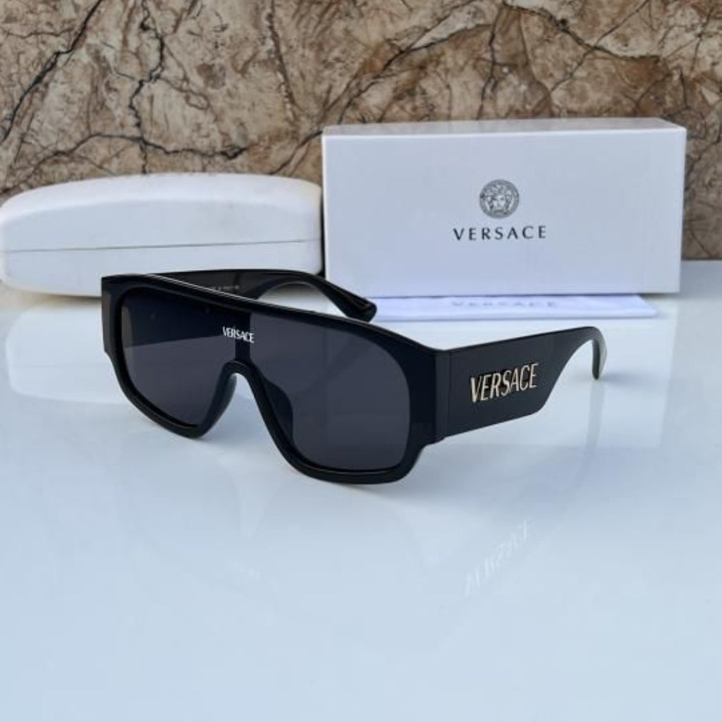 Black Versace sunglasses with packaging on a marble surface