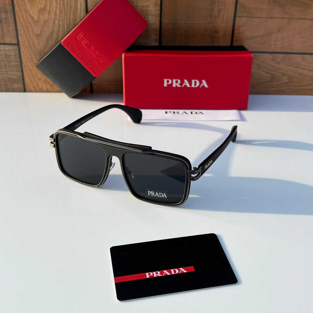 Prada sunglasses with red and black Prada card and box on a wooden surface